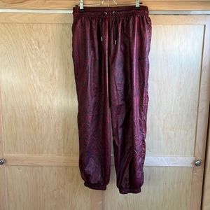 Nike nylon track pants. Red and black snakeskin pattern.